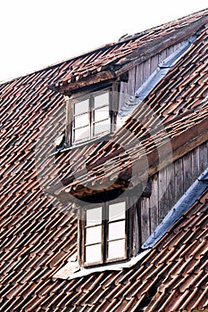 The windows of the historic building of the 18th century on the roof