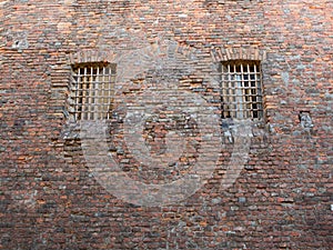 Windows with iron grills in an ancient medieval castle
