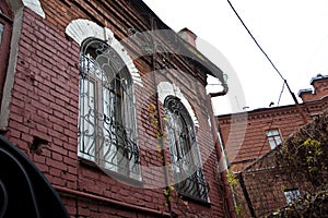 Windows with lattice. Old red brick mansion. Voronezh