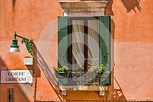 Windows on the old building in Venice canal, Italy