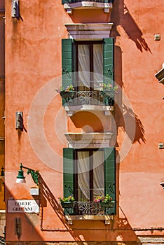 Windows on the old building in Venice canal, Italy