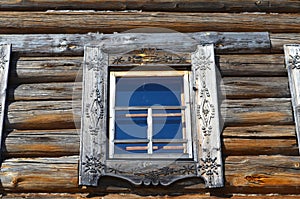 Windows of old farm house in open-air museum Malye Korely featuring the traditional wooden architecture of Arkhangelsk area