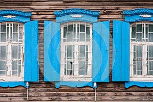 Windows of old, wooden cottage in the countryside