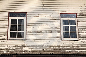 Windows and old wooden wall of cottage