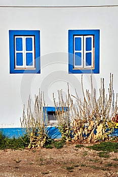Windows painted blue in a Greek house