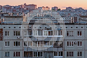 Windows, roofs and facade of an mass apartment buildings in Russia photo