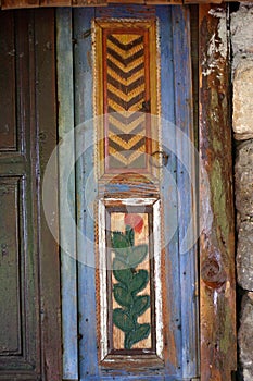 Windows with shutters, patterned on the wall of the old wooden