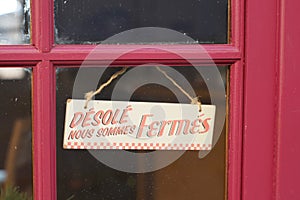 Windows sign shop panel write in french desole nous sommes ferme means sorry we are closed on store entrance