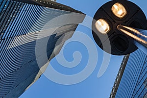 Windows of skyscraper business office building with street lamp at front, Corporate buildings in city