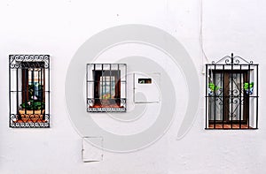 Windows with steel lattice on a whitewashed wall