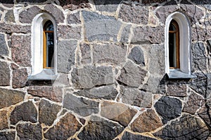 Windows in stone wall.