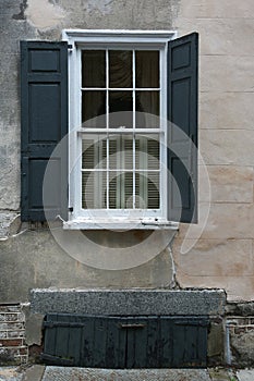 Windows, stone wall, black shutters