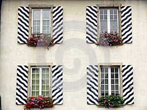 Windows with striped decorated shutters