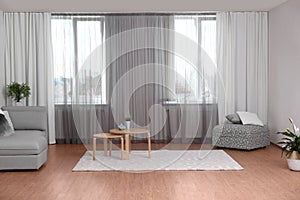 Windows with stylish curtains in living room