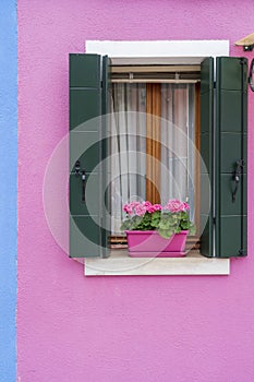 Windows of Venice, Murano and Burano. Picturesque windows with shutters on the famous island Burano. Decorated window on colorful