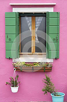 Windows of Venice, Murano and Burano. Picturesque windows with shutters on the famous island Burano. Decorated window on colorful
