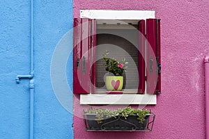 Windows of Venice, Murano and Burano. Picturesque windows with shutters on the famous island Burano. Decorated window on colorful