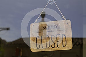 Windows vintage wooden shop sign saying sorry we are closed