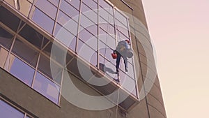 Windows washing skyscraper mountain climber