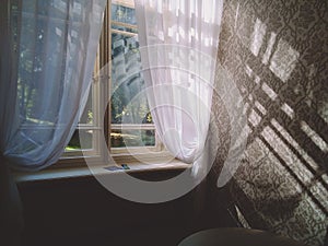 Windows with white curtains. The wall texture under sunlight.