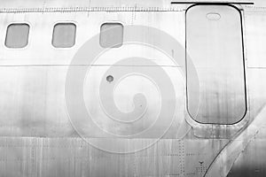 Windows of the white metal surface airplane with emergency exit security escape