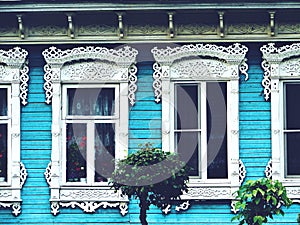 Windows on a a wooden house wall