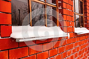 Windowsills with snow in brick wall