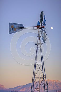 Windpump against mountain and sky with moon