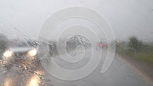 Windscreen wiper clean the glass on a car that rides in the rain on a bad road