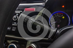 Windscreen wiper control switch in car. Wipers control. Modern car interior detail. adjusting speed of screen wipers in car.