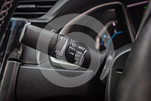 Windscreen wiper control switch in car. Wipers control. Modern car interior detail. adjusting speed of screen wipers in car.