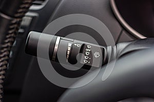 Windscreen wiper control switch in car. Wipers control. Modern car interior detail. adjusting speed of screen wipers in car.