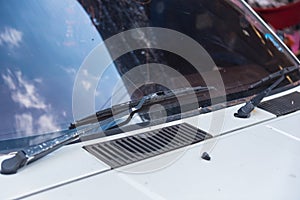 A windscreen wiper or windshield wiper is a device used to remove rain, snow, ice and debris from a windscreen or windshield