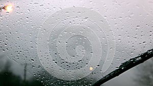 Windscreen wiper wiping rain away from car window