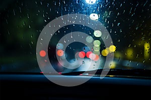 Through the windshield, a car navigates the rainy nights mysteries