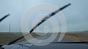 windshield of a car in the rain. view from the car on a rainy day