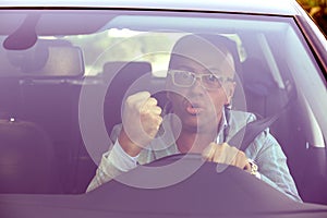 Windshield view of an angry driver man
