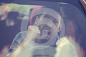 Windshield view of an angry driver man.