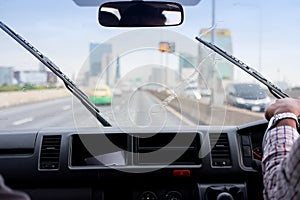 Windshield wipers from inside of car, rainy season