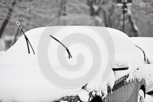 Windshield wipers of an snow covered car