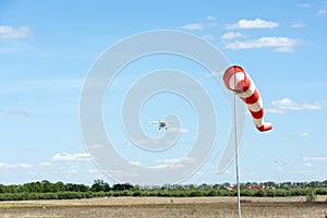 Windsock against cloudy sky.
