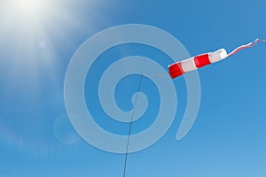 Windsock on a background of blue sky on a sunny day