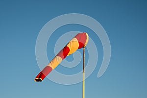 Windsock on blue sky background