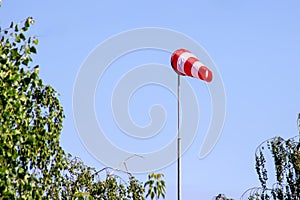Windsock indicating wind on blue sky background