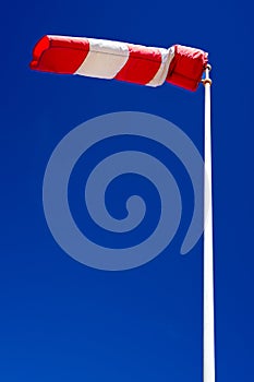 windsock in operation with strong blue sky background.