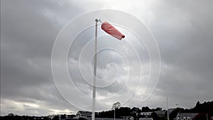 Windsock on post with cloudy and stormy sky in the background
