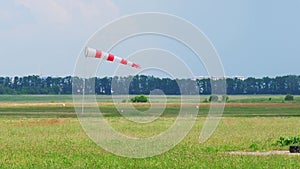Windsock red and white on a dirt airfield