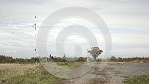 Windsock in wind, meteorology wind sock, two riders on horseback