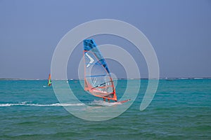 Windsurfer at Jibe City windsurfing in Bonaire clear skies