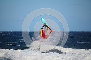 Windsurfer during a jump called backloop in the waves of the Atlantic Ocean, Tenerife, Spain